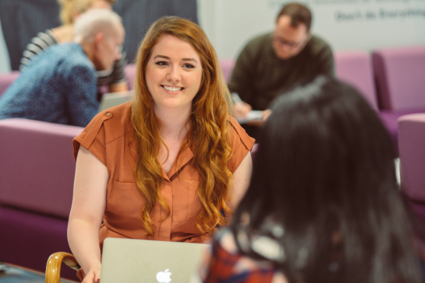 Rachael Harvey, Digital, Data and Technology Fast Streamer, smiling and talking to a colleague