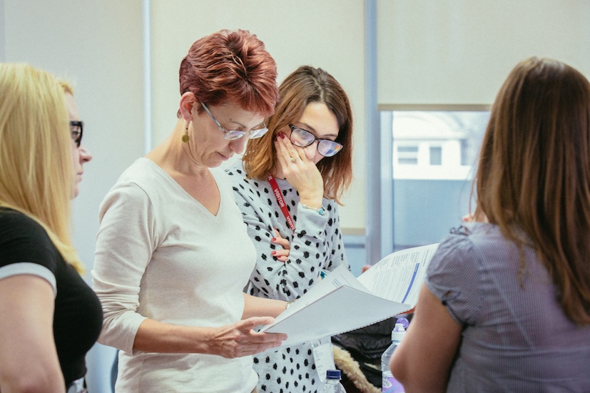 Lorena Sutherland, talking to her colleagues in an office