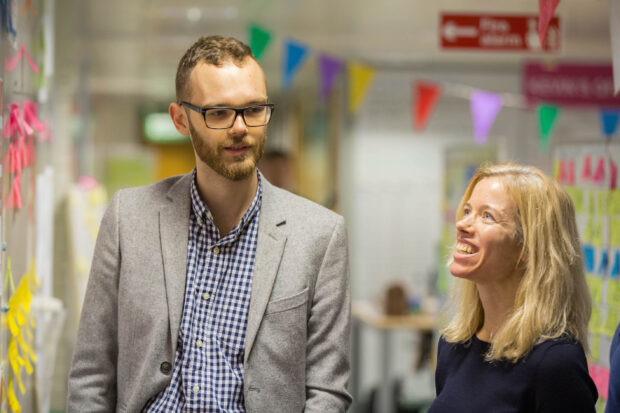  Jonathan Hallam, Digital, Data and Technology Fast Tracker, talking to his colleague next a post-it note white board