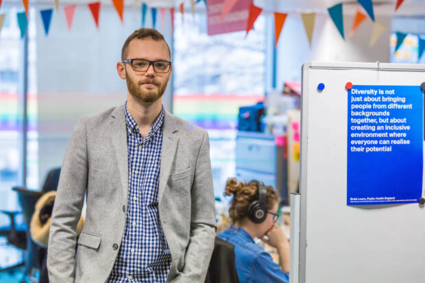  Jonathan Hallam, standing in front of the camera in an office