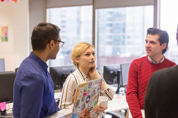 Shana Austin talking to her colleagues