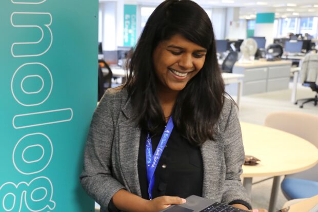 Mary smiling an looking at her laptop