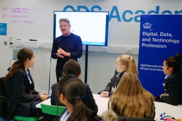 Kevin Cunnington, Director General of GDS and Head of the DDaT Profession, talks to a group of students