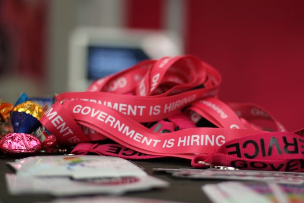 Lanyards with the writing "Government is hiring"