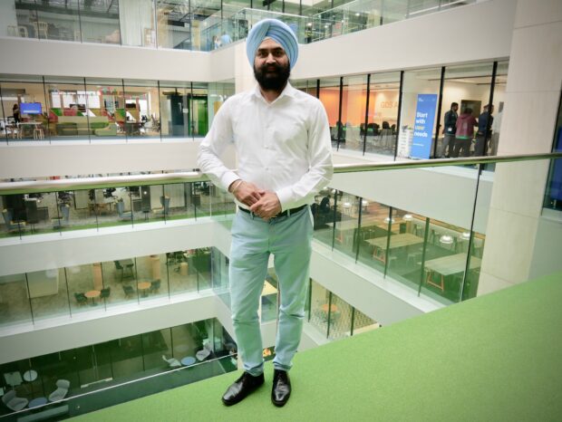 Ravinder Singh standing on the balcony at the GDS