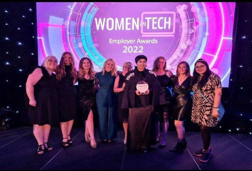 Image shows members of the HMRC award winning team with their award at the Women In Tech awards ceremony